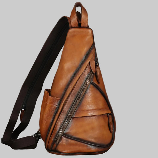 A brown retro leather sling bag with a shoulder strap, featuring multiple zippered compartments and a tablet sleeve.