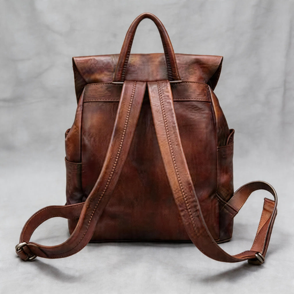 Brown leather backpack on a light gray background