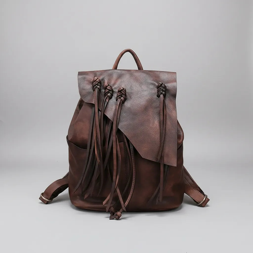 Brown leather backpack on a light gray background