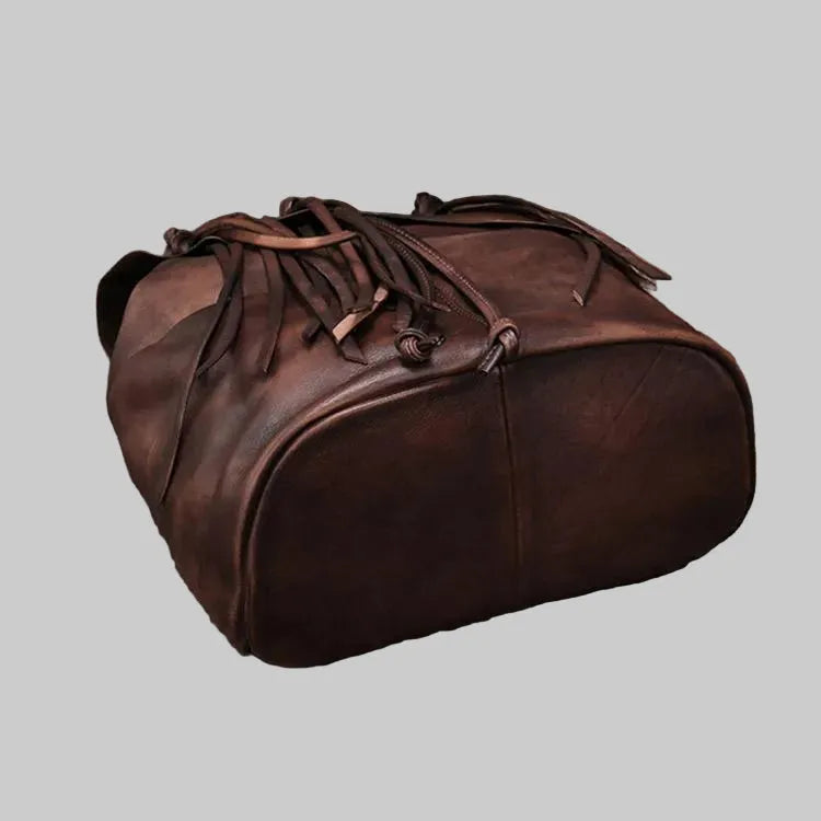 Brown leather duffel bag on a light gray background