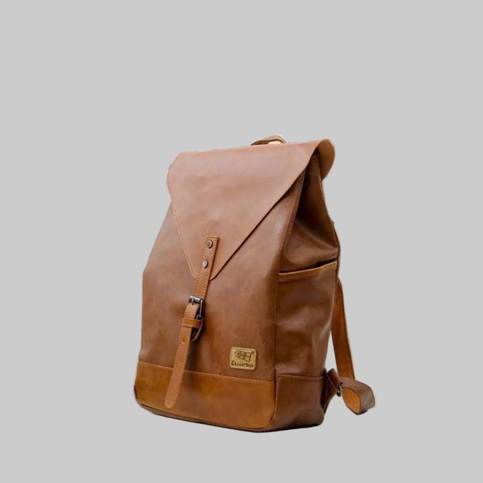 Brown leather backpack on a light gray background