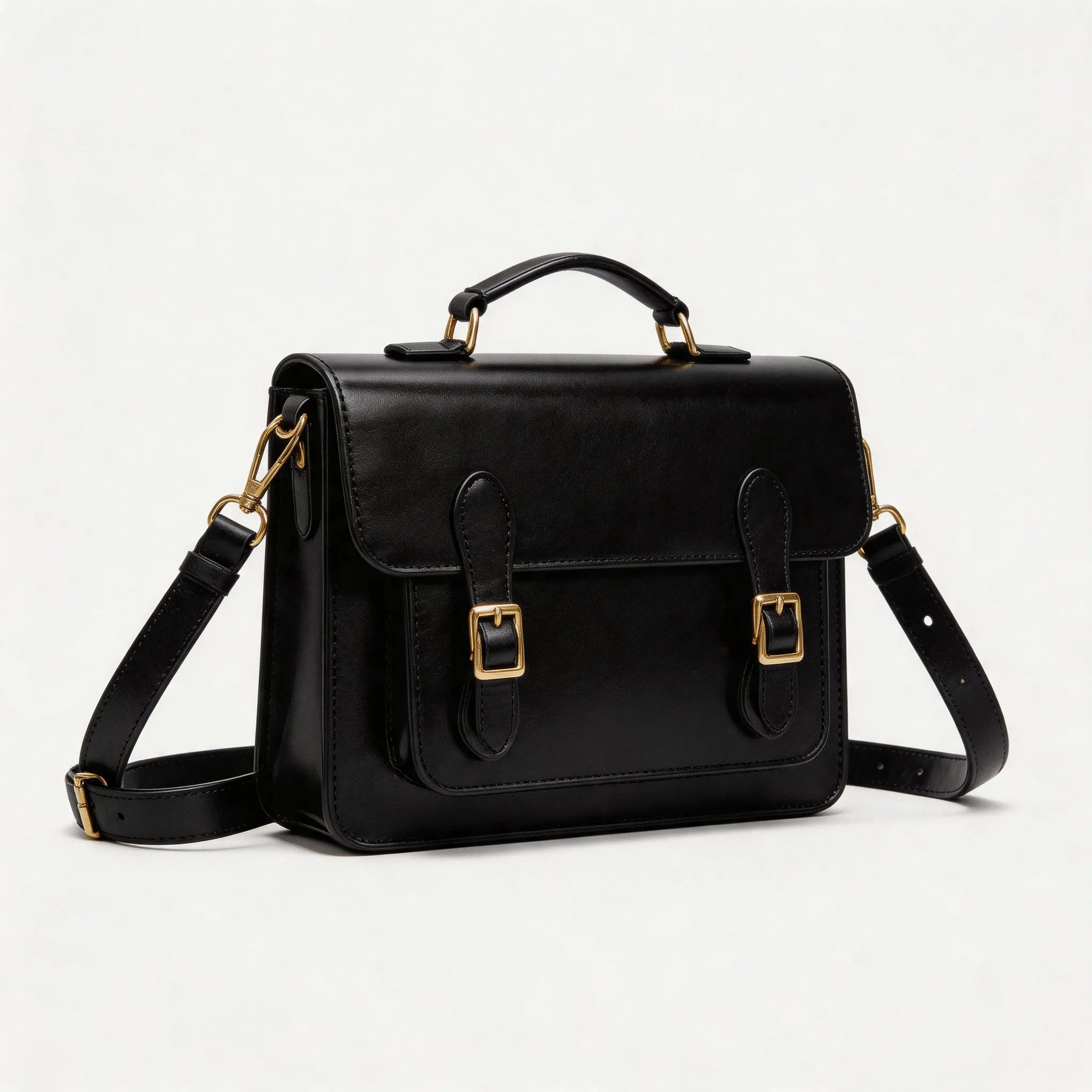 Black leather satchel bag with gold accents on a white background
