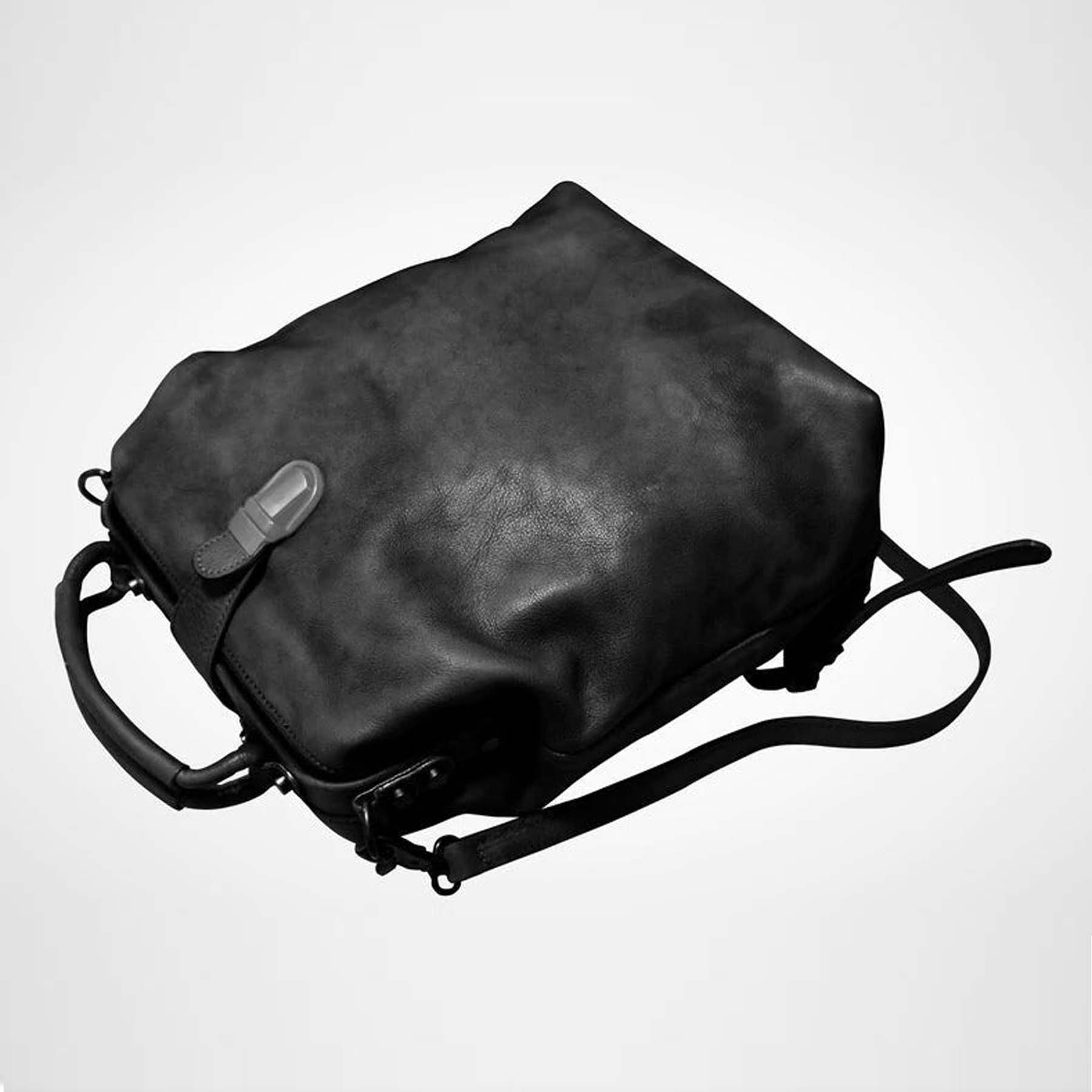 Black leather bag on a light gray background