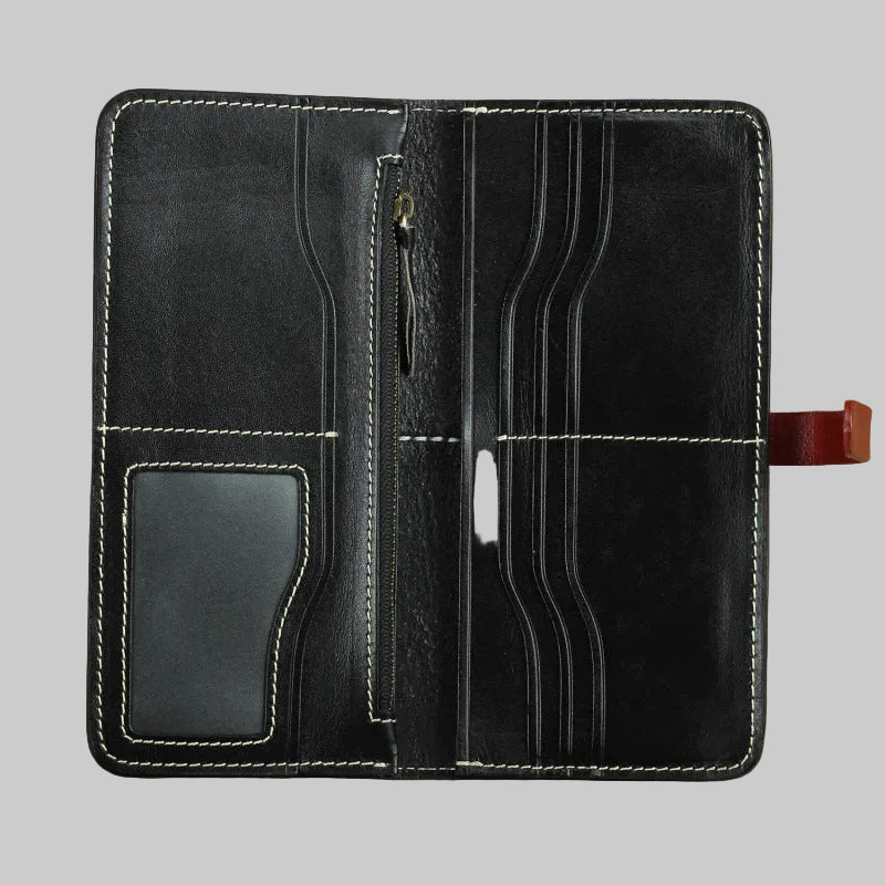 Black leather wallet with card slots and a zipper on a brown background