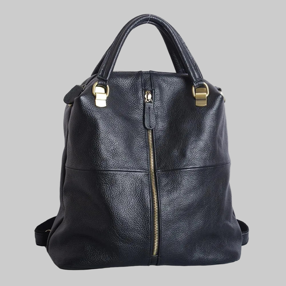 A black leather backpack with a soft handle, gold-tone hardware, and a front zipper closure. It has shoulder straps and appears to be standing upright on a plain background.