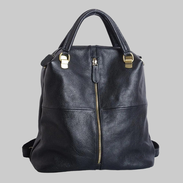 A black leather backpack with a soft handle, gold-tone hardware, and a front zipper closure. It has shoulder straps and appears to be standing upright on a plain background.