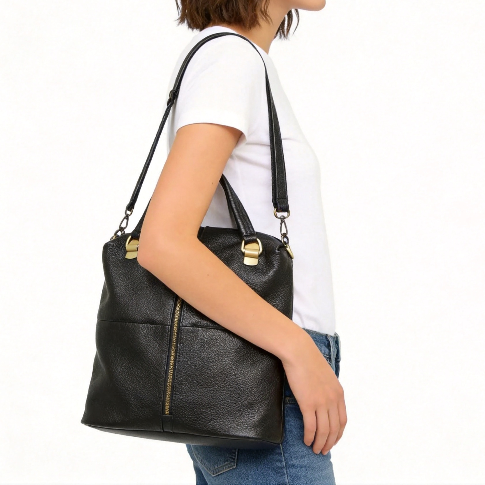 Woman carrying a black leather handbag on a white background