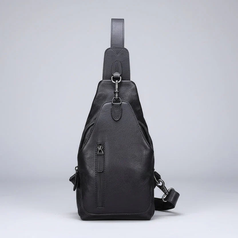 Black leather sling bag on a light gray background