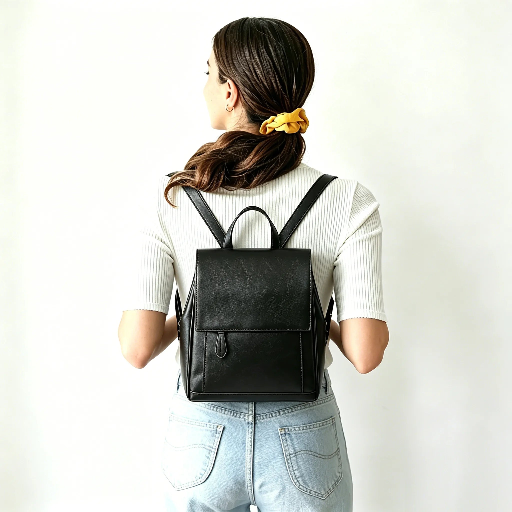 Person wearing a black backpack against a white background