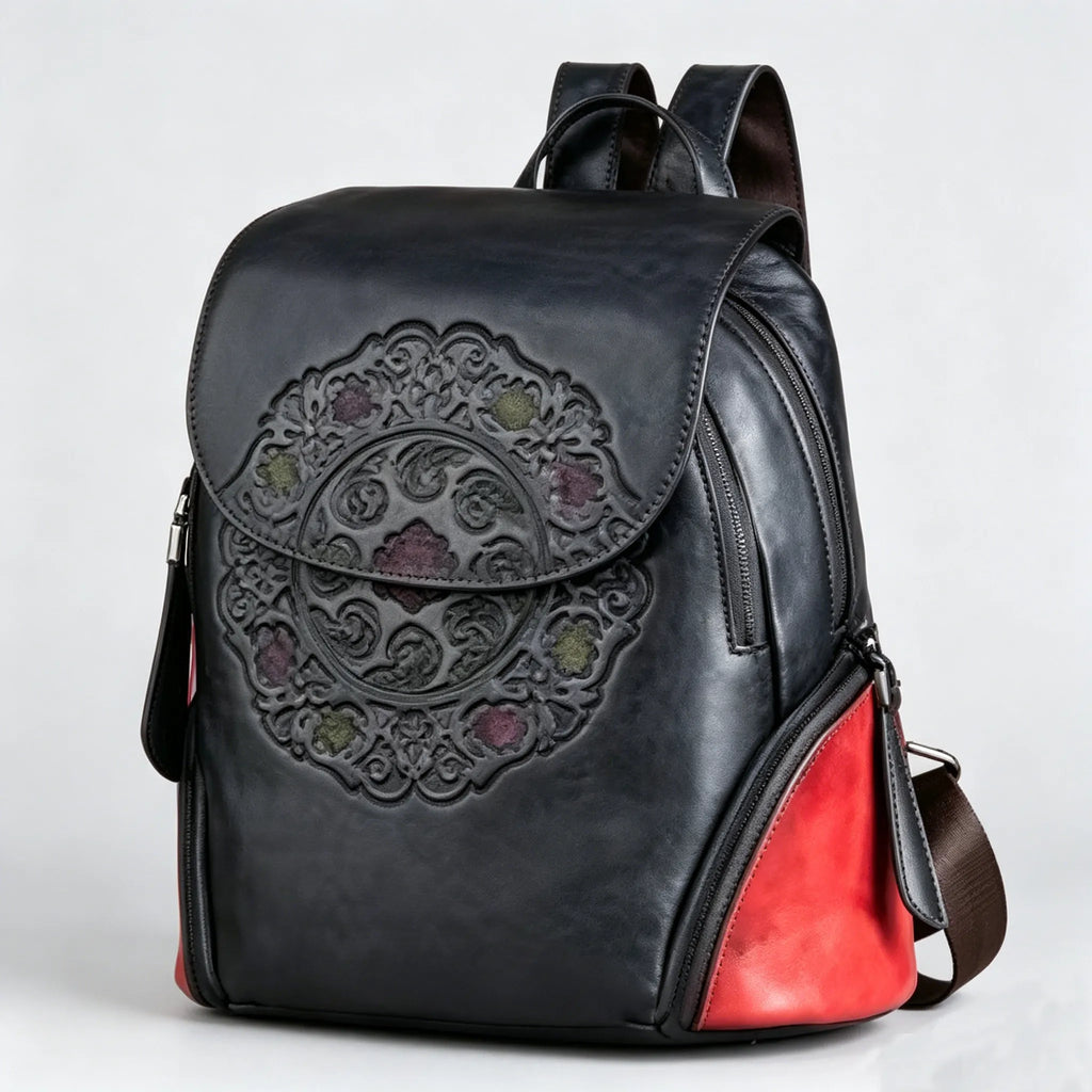 Black leather backpack with red interior on a light gray background
