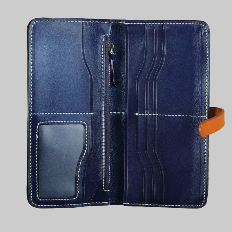 Blue leather wallet with orange pull tab on a brown background