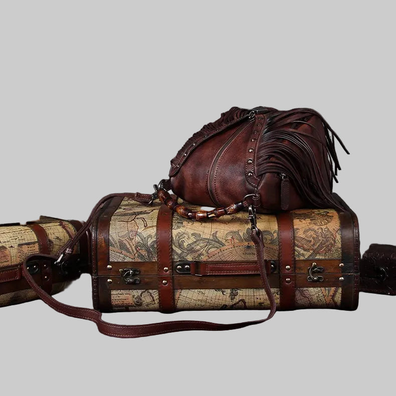 Brown leather bag with map design on a light gray background