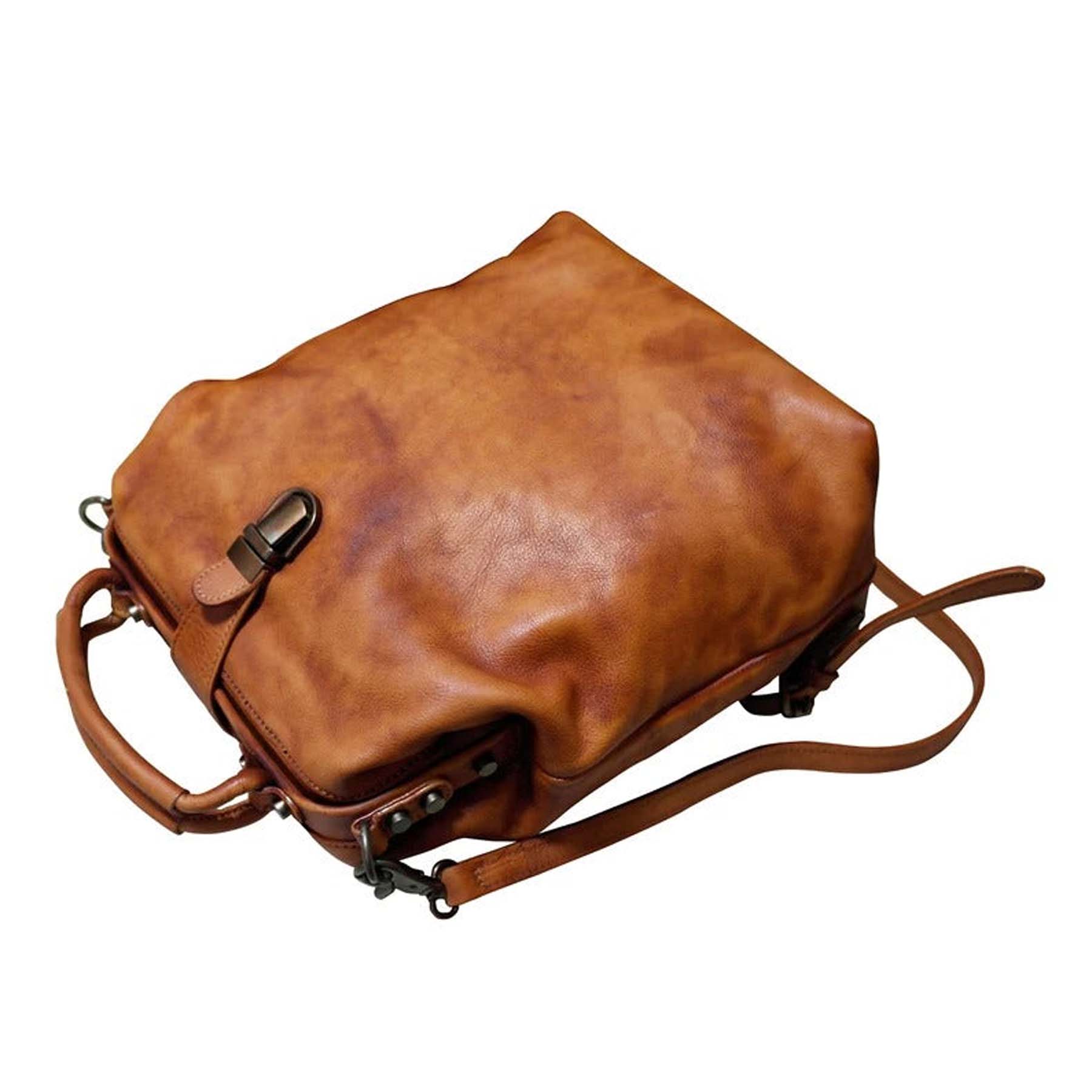 Brown leather bag with a strap on a white background