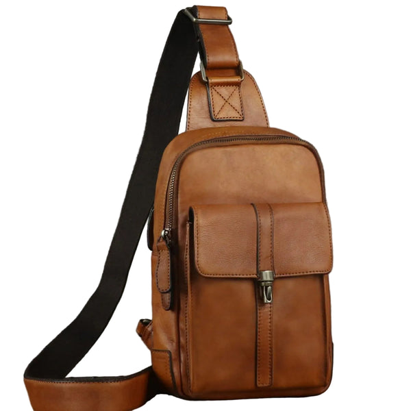 A brown leather crossbody bag with a wide black adjustable strap, shown on a plain white background.