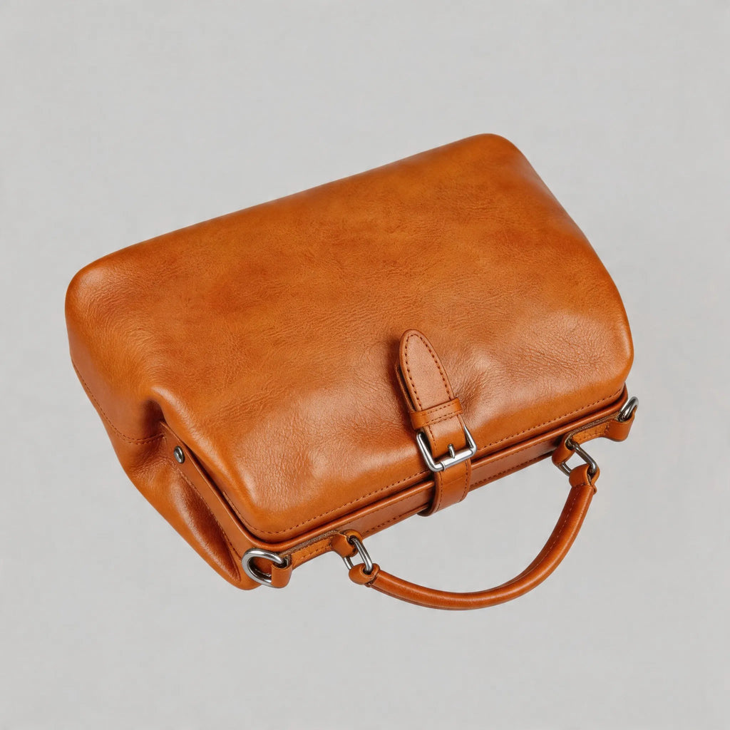 Brown leather handbag on a light gray background