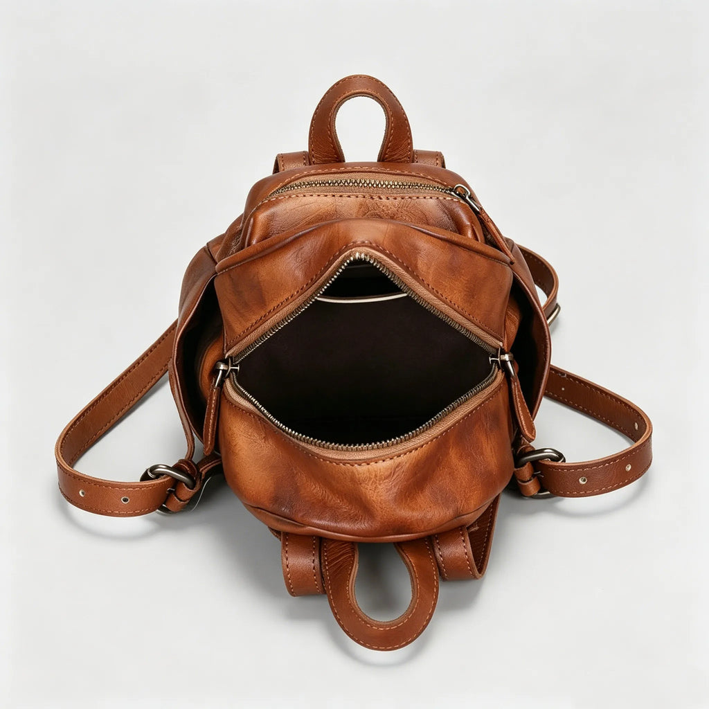 Brown leather backpack on a light gray background