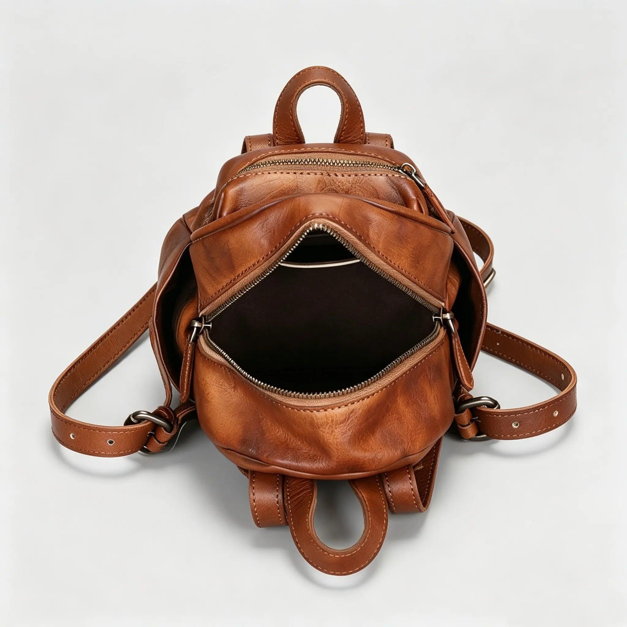Brown leather backpack on a light gray background