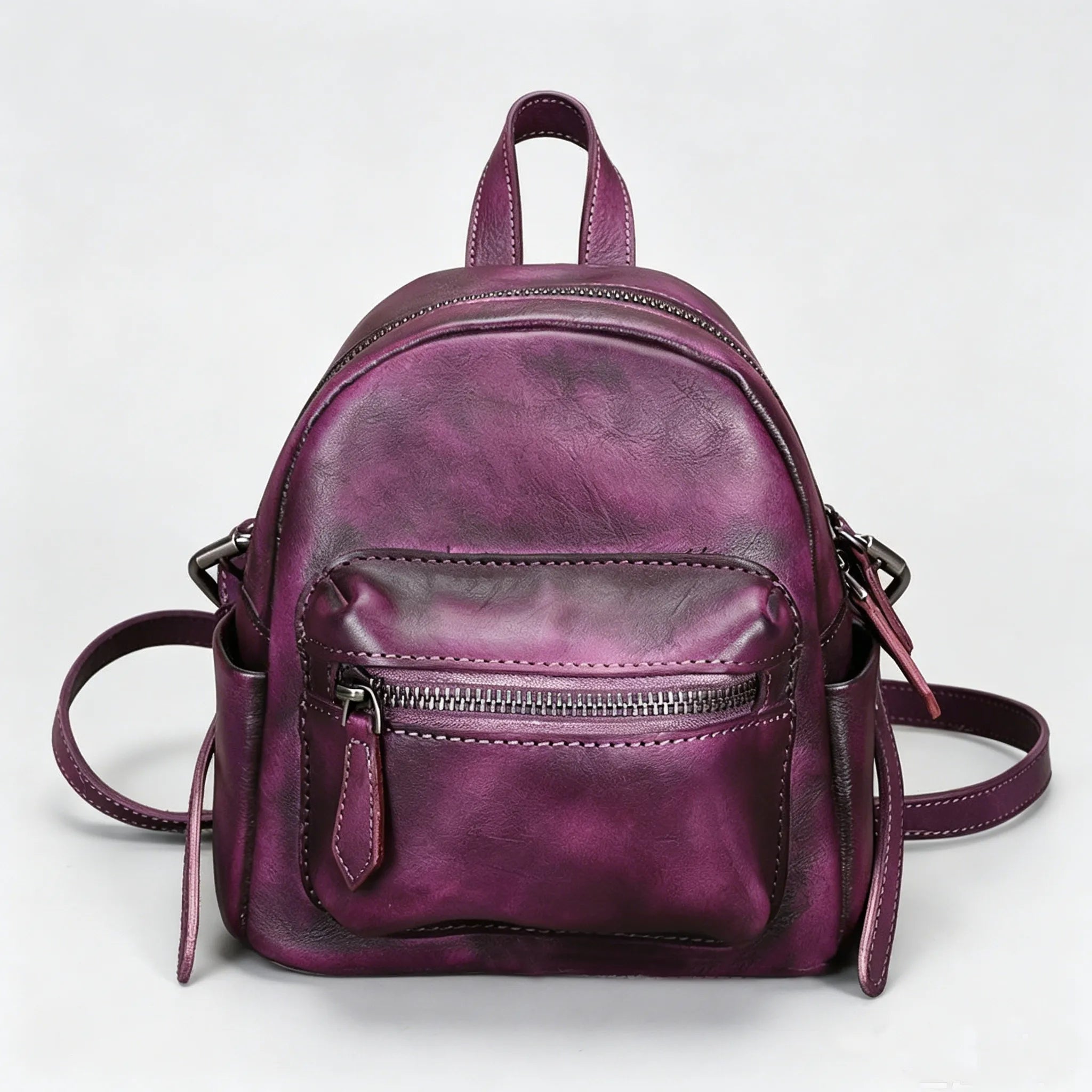 Purple leather backpack on a white background