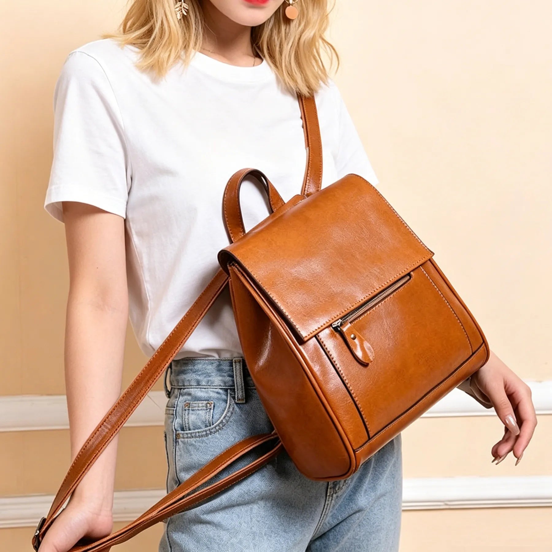 Person wearing a brown backpack against a beige background