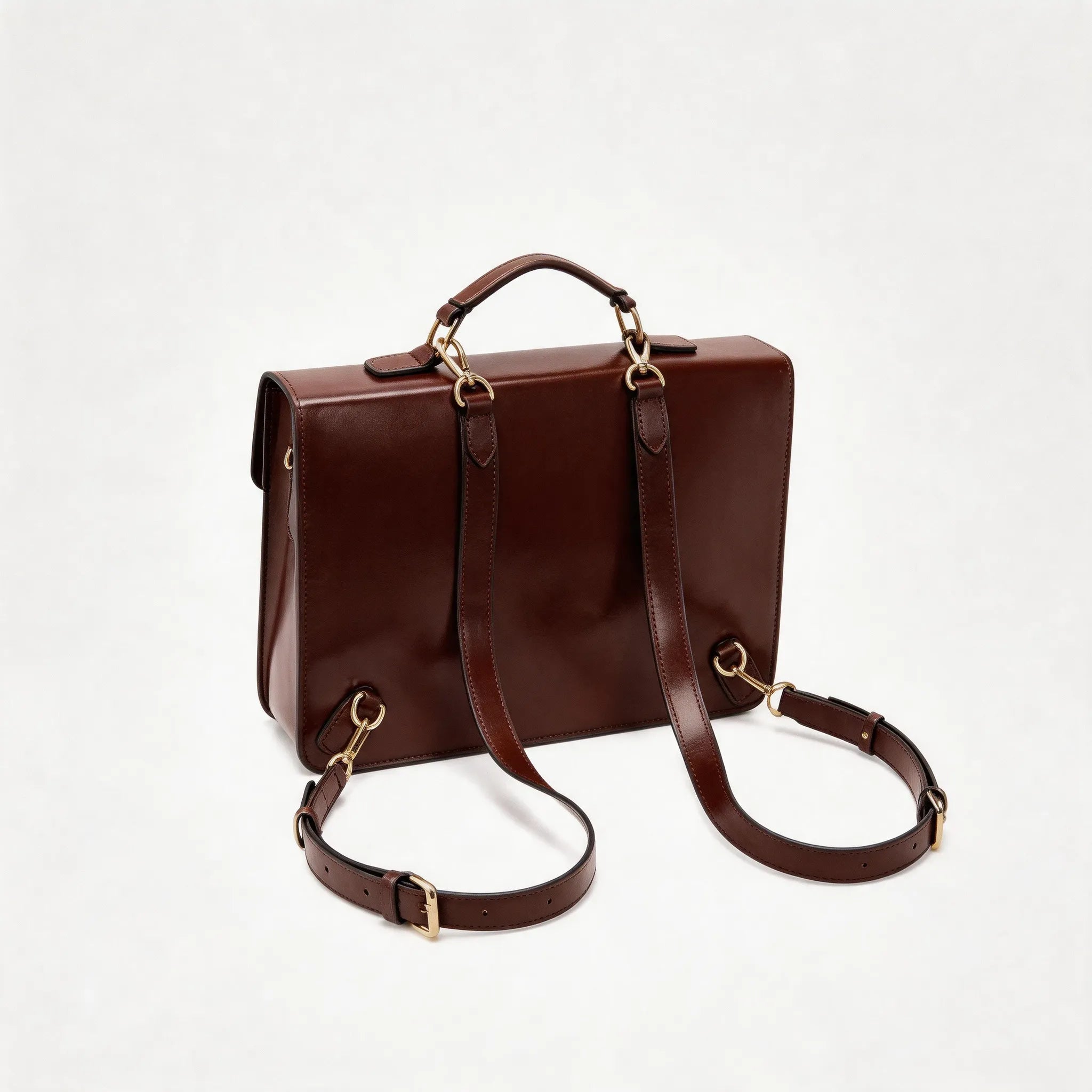 Brown leather satchel bag with a shoulder strap on a white background
