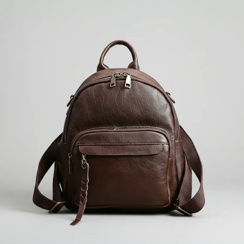 Brown leather backpack on a light gray background
