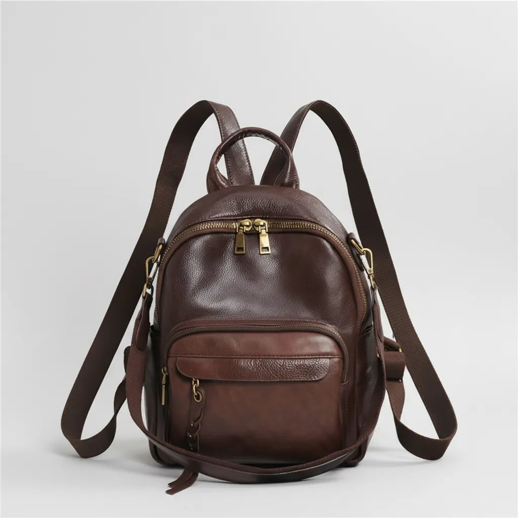 Brown leather backpack on a light gray background