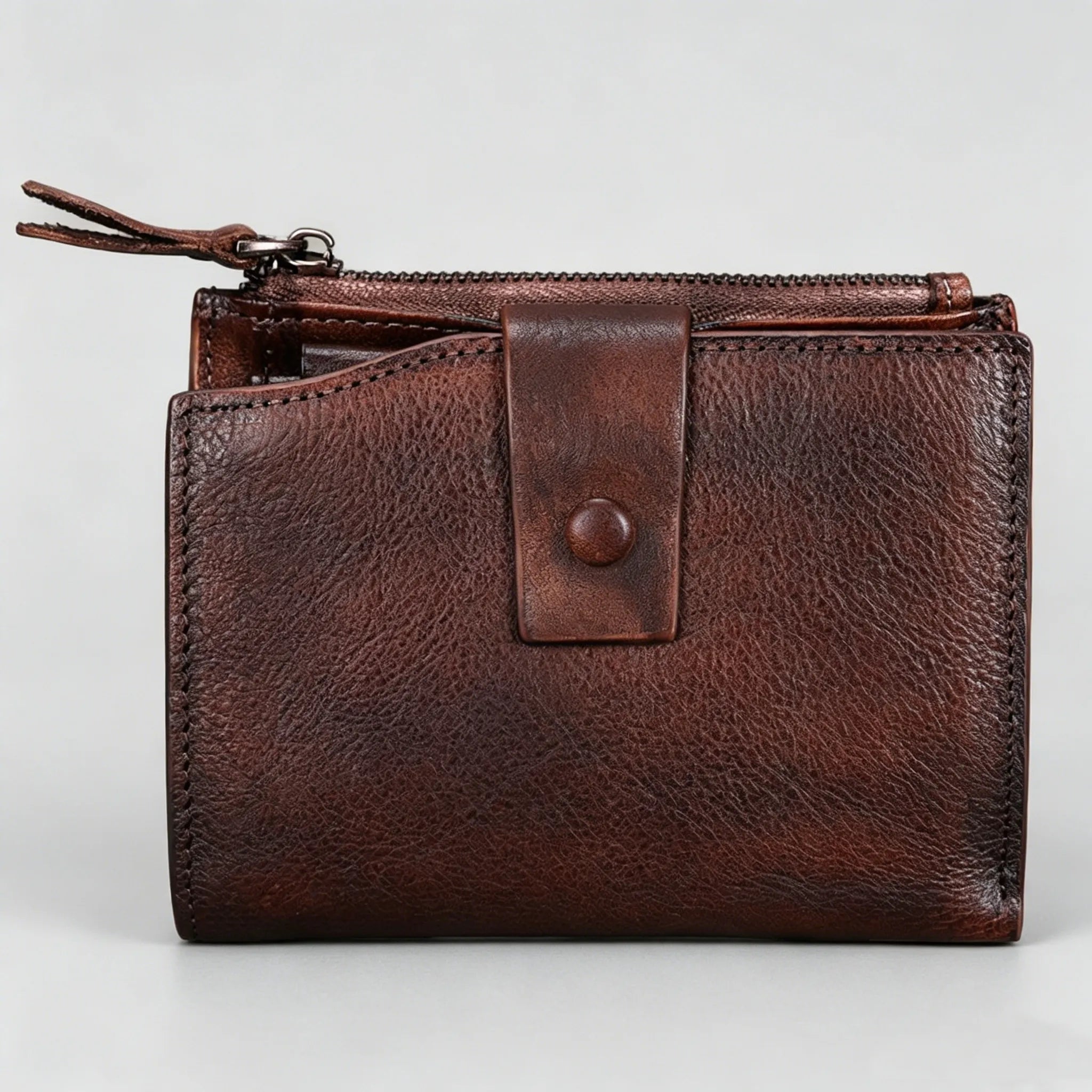 Brown leather wallet with a zipper on a light gray background