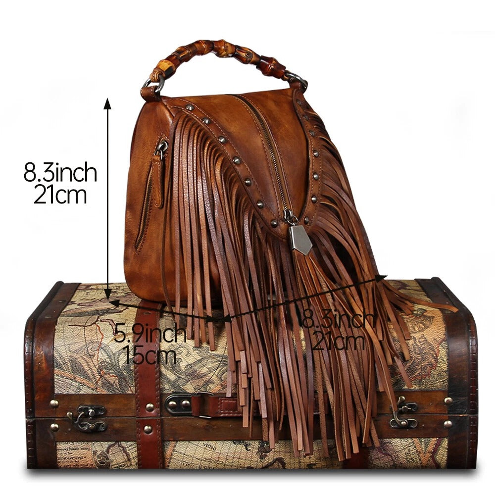 Brown leather handbag with fringe details on a map-themed chest, showing measurements.