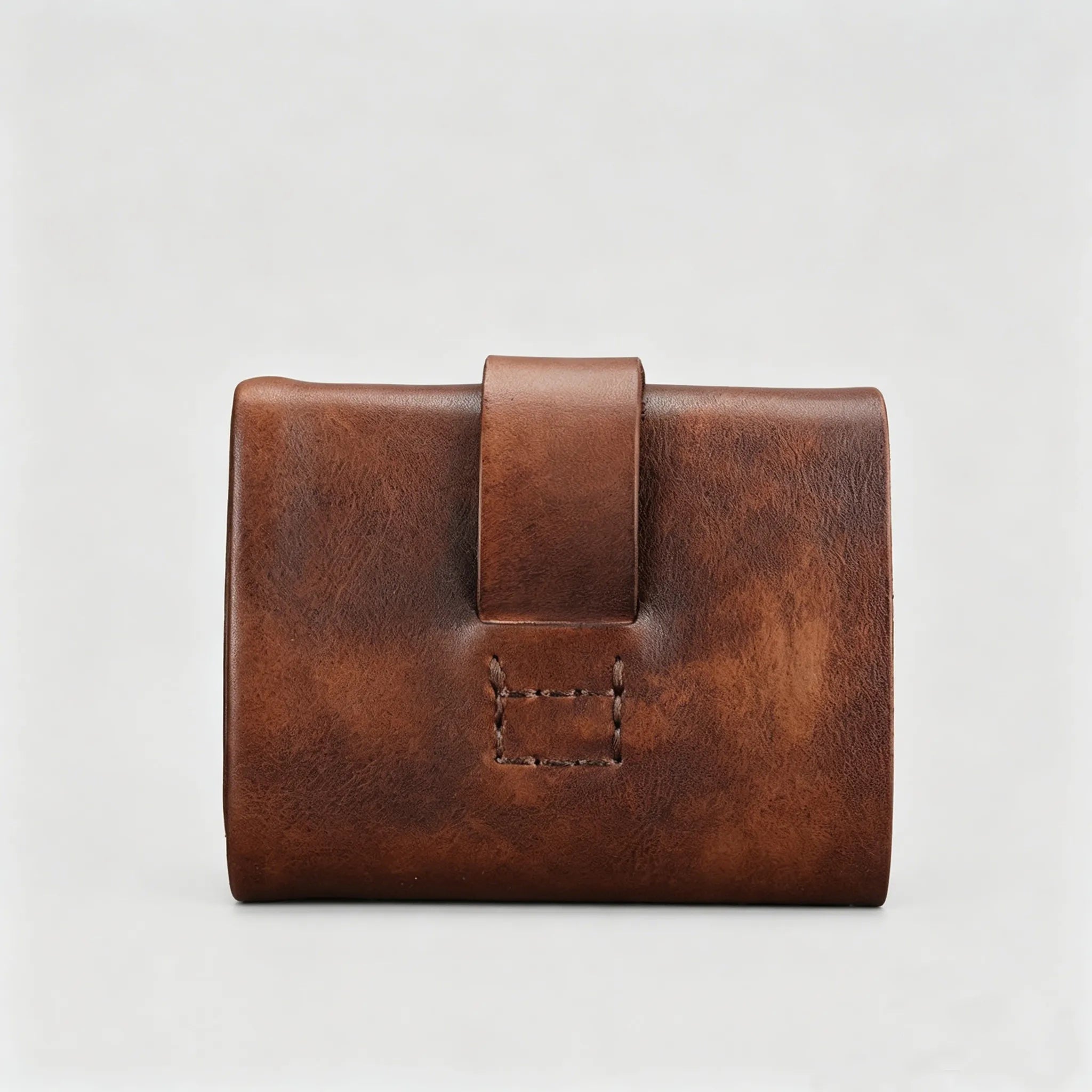 Brown leather wallet on a light gray background