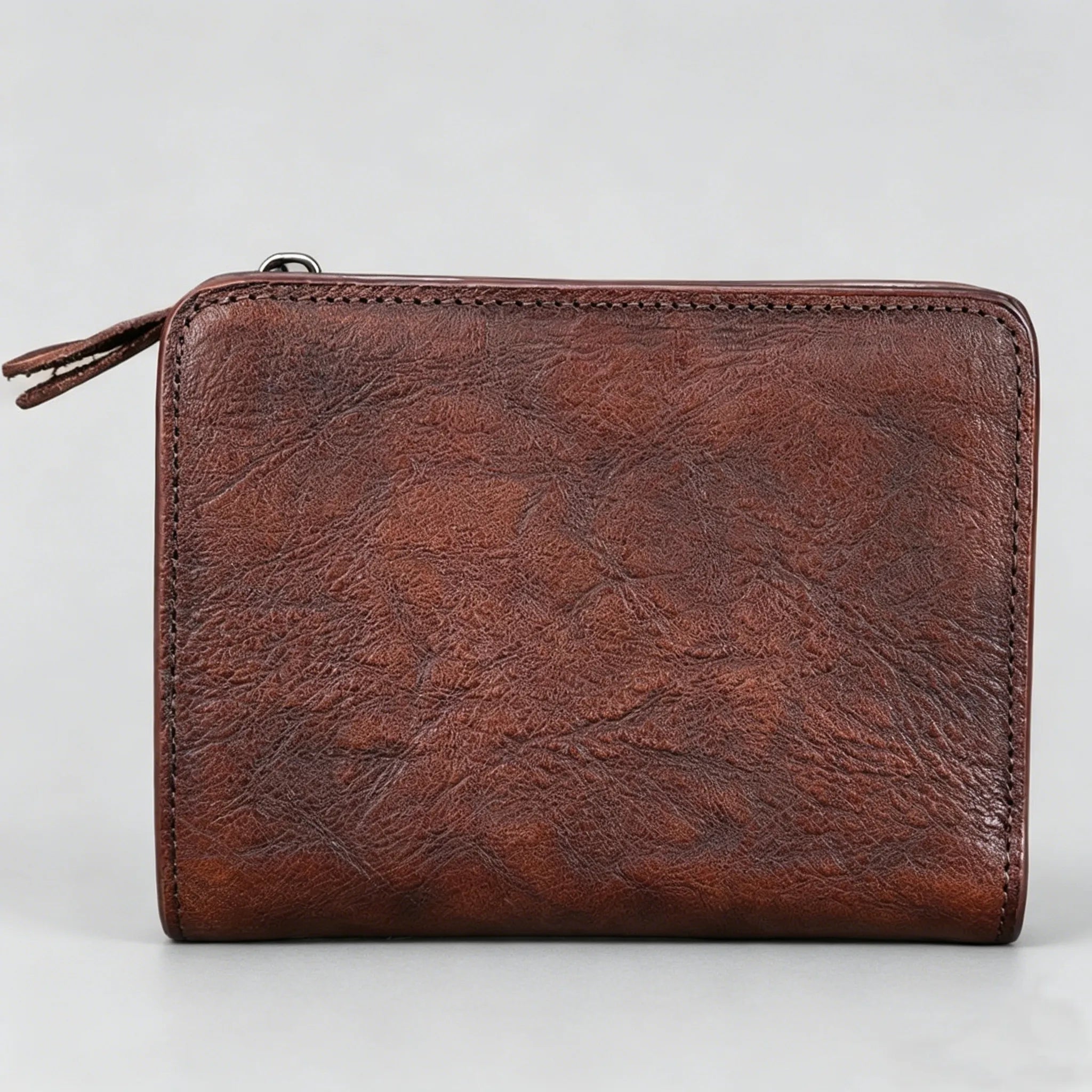 Brown leather wallet on a light gray background