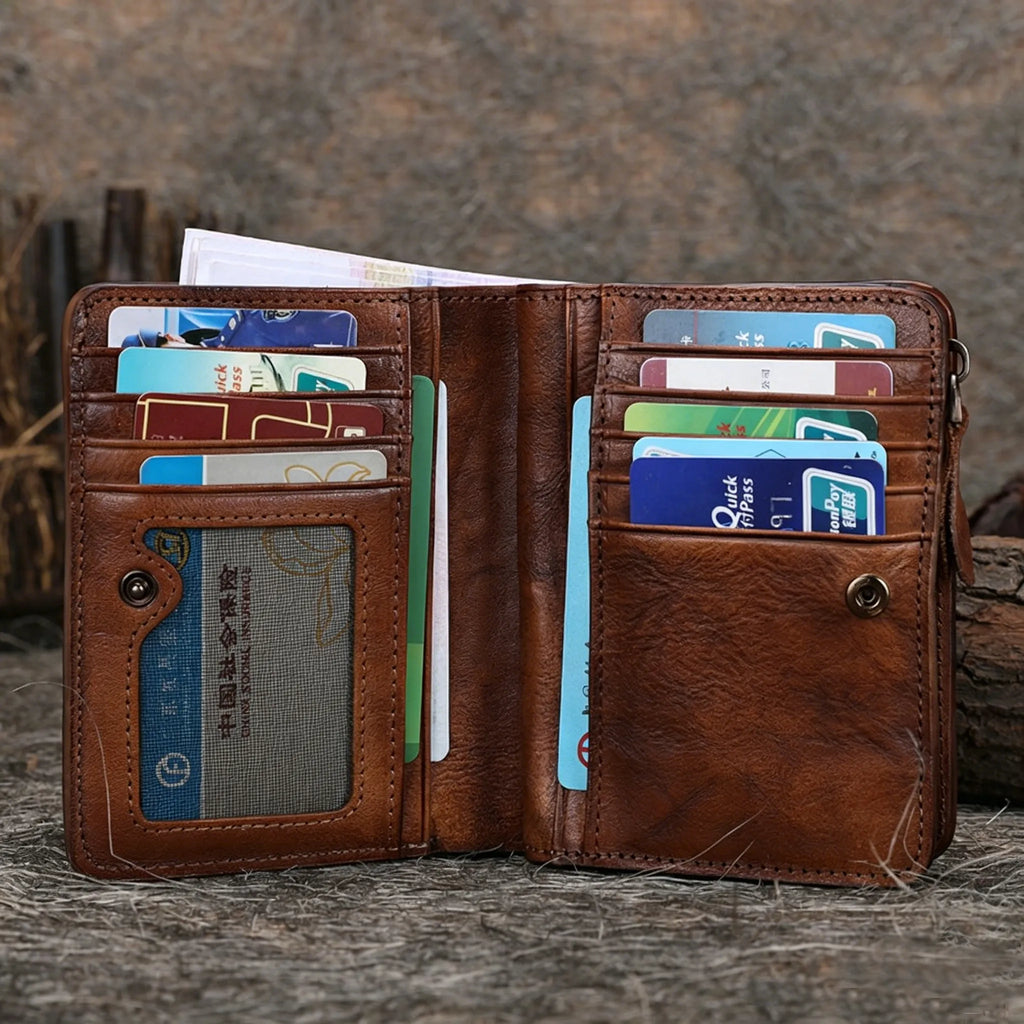 Brown leather wallet with multiple cards and a cardholder on a wooden surface.
