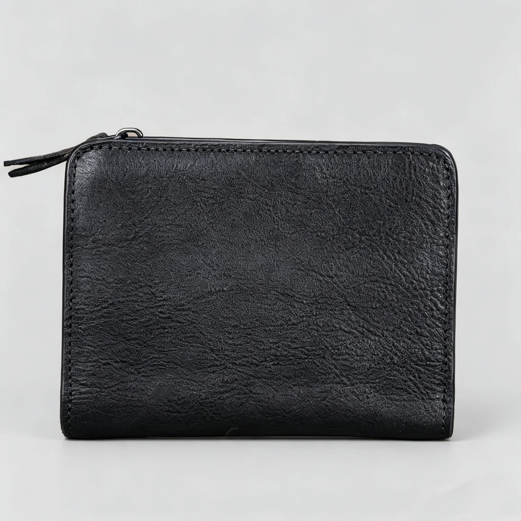 Black leather wallet on a light gray background