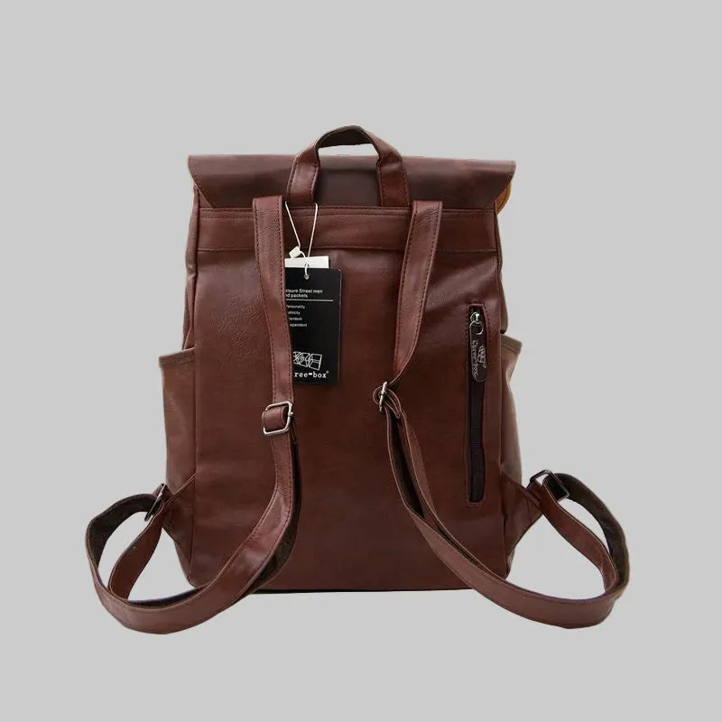 Brown leather backpack with a visible brand tag on a gray background