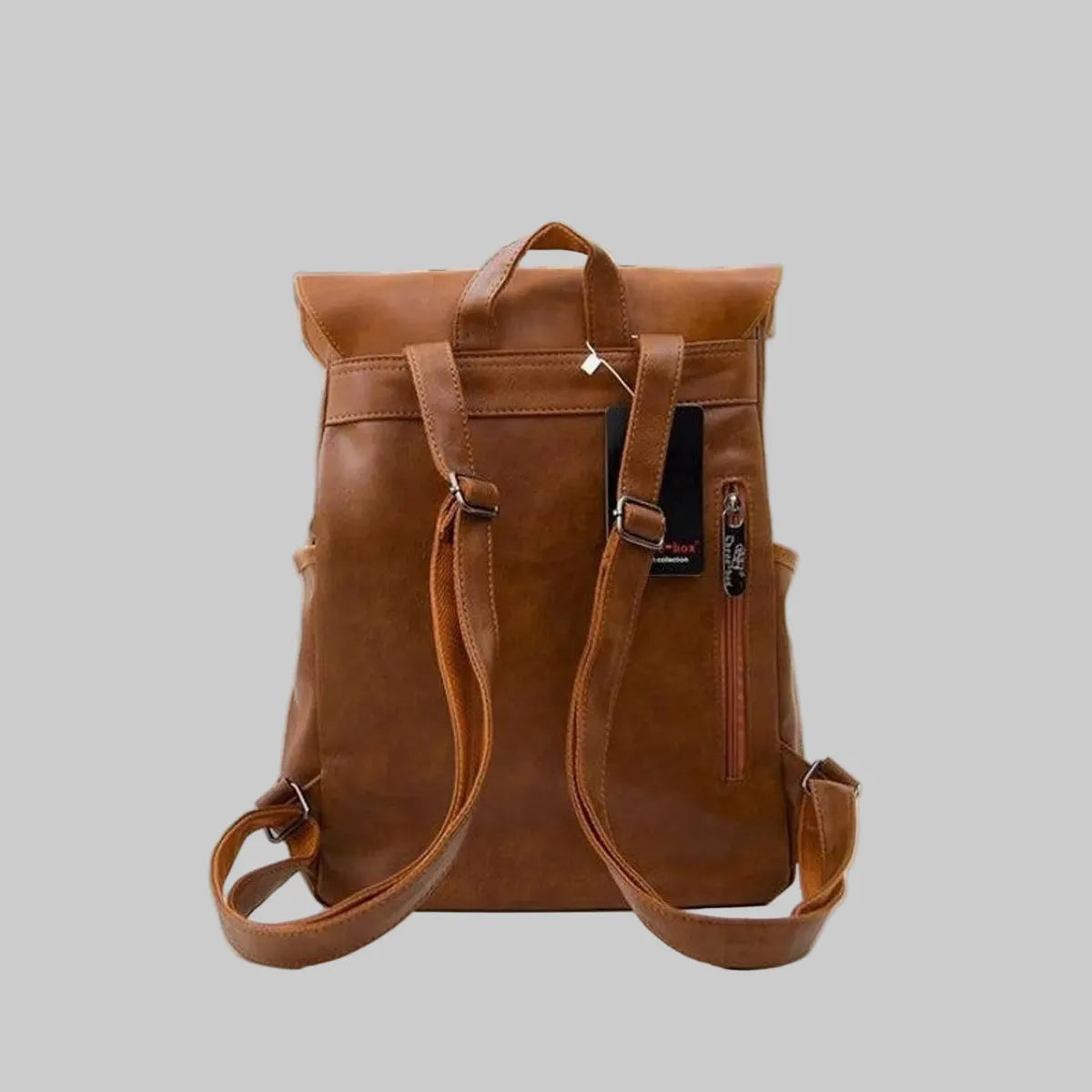 Brown leather backpack on a gray background