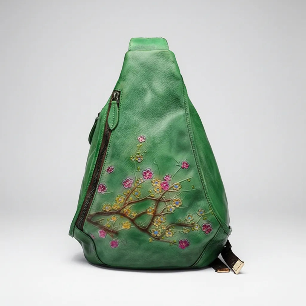 Green sling bag with floral embroidery on a white background