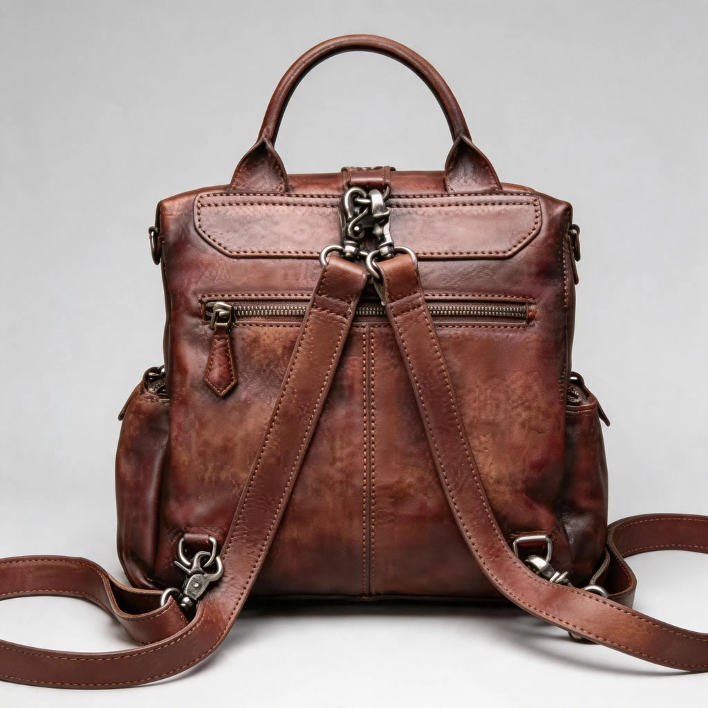Brown leather backpack on a light gray background