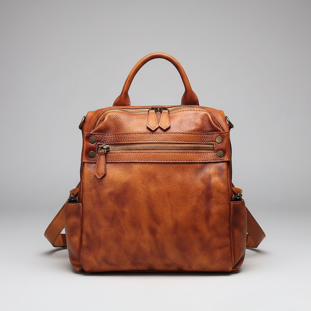 Brown leather backpack on a gray background