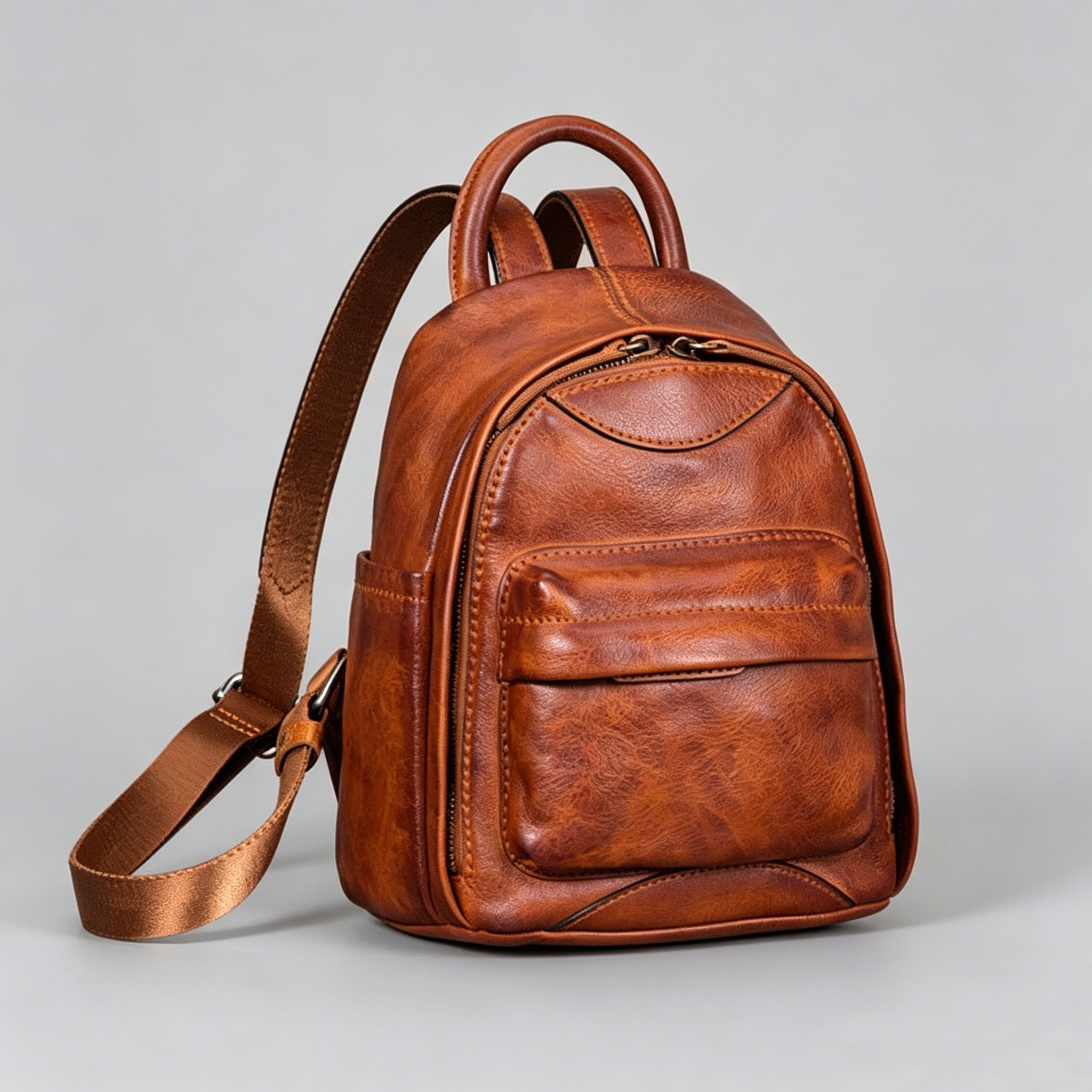 Brown leather backpack on a light gray background