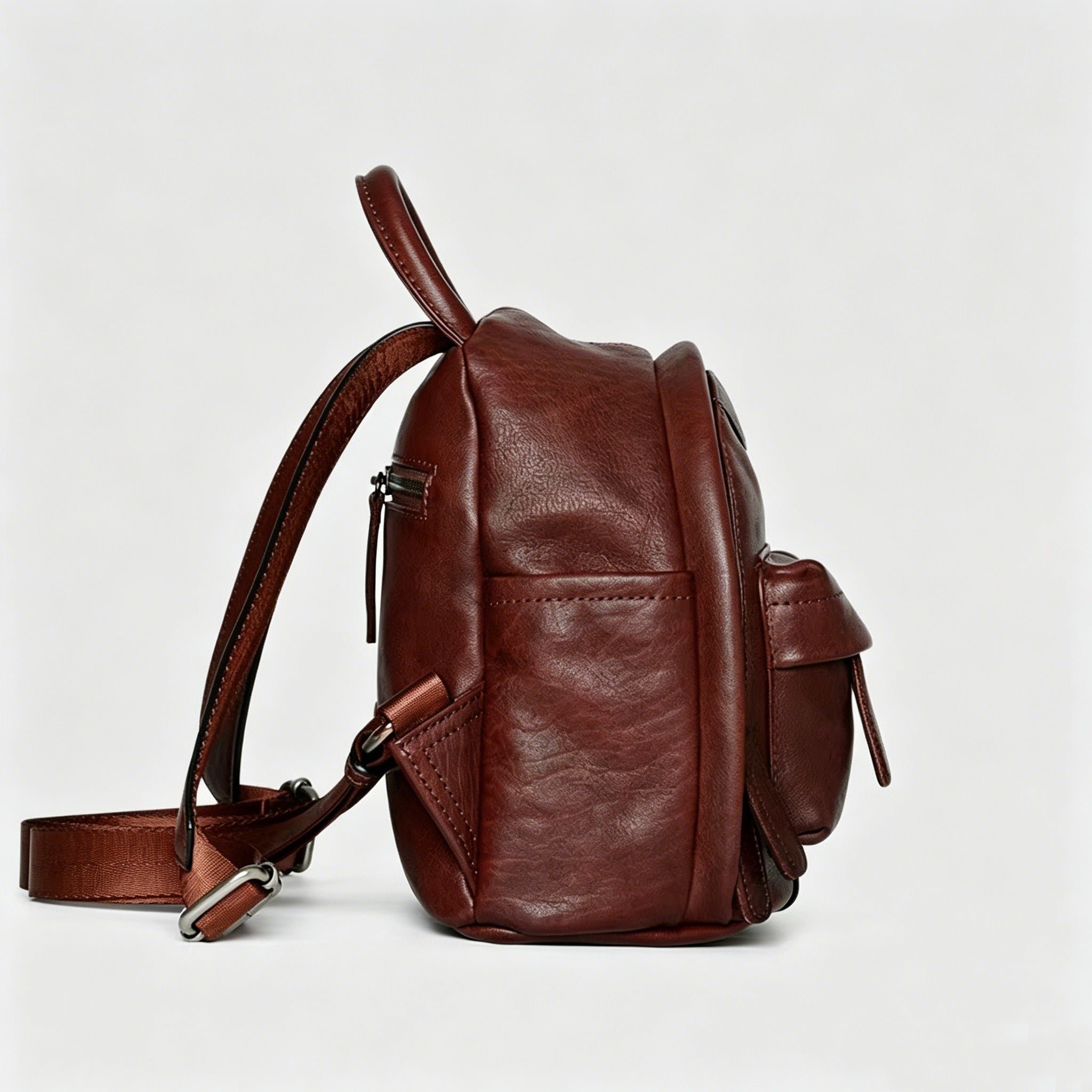 Brown leather backpack on a light gray background