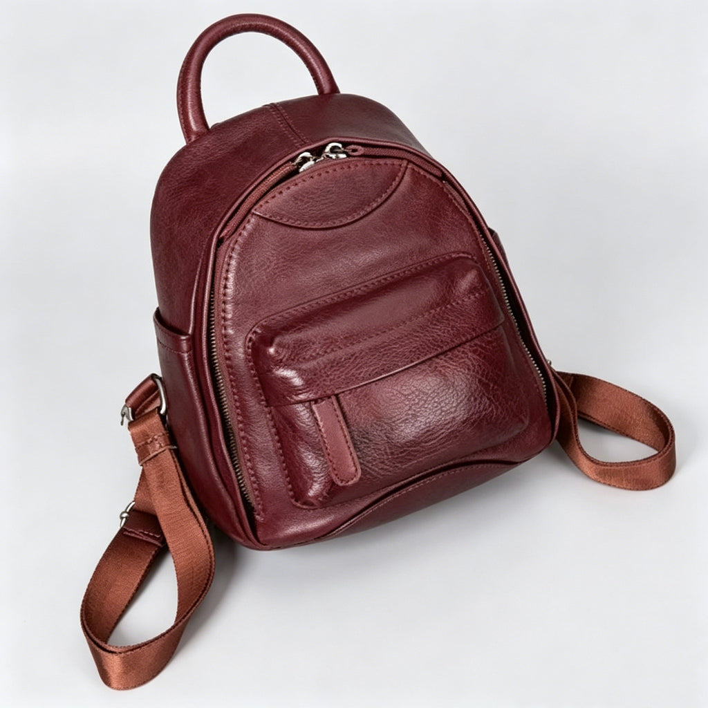 Brown leather backpack on a light gray background
