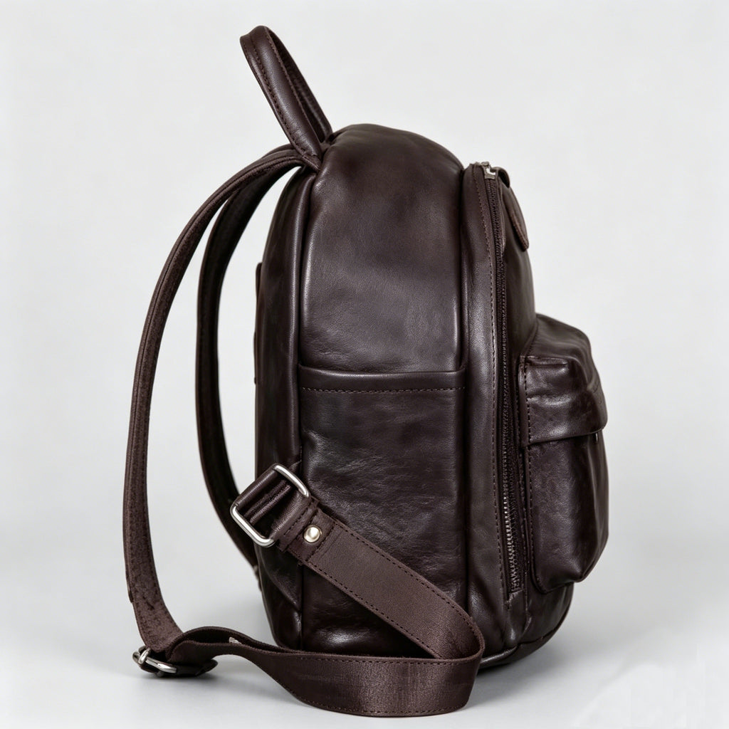Brown leather backpack on a light gray background