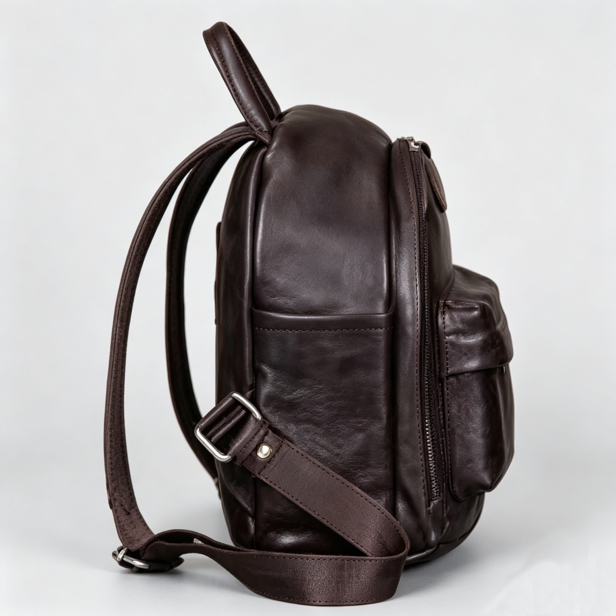 Brown leather backpack on a light gray background
