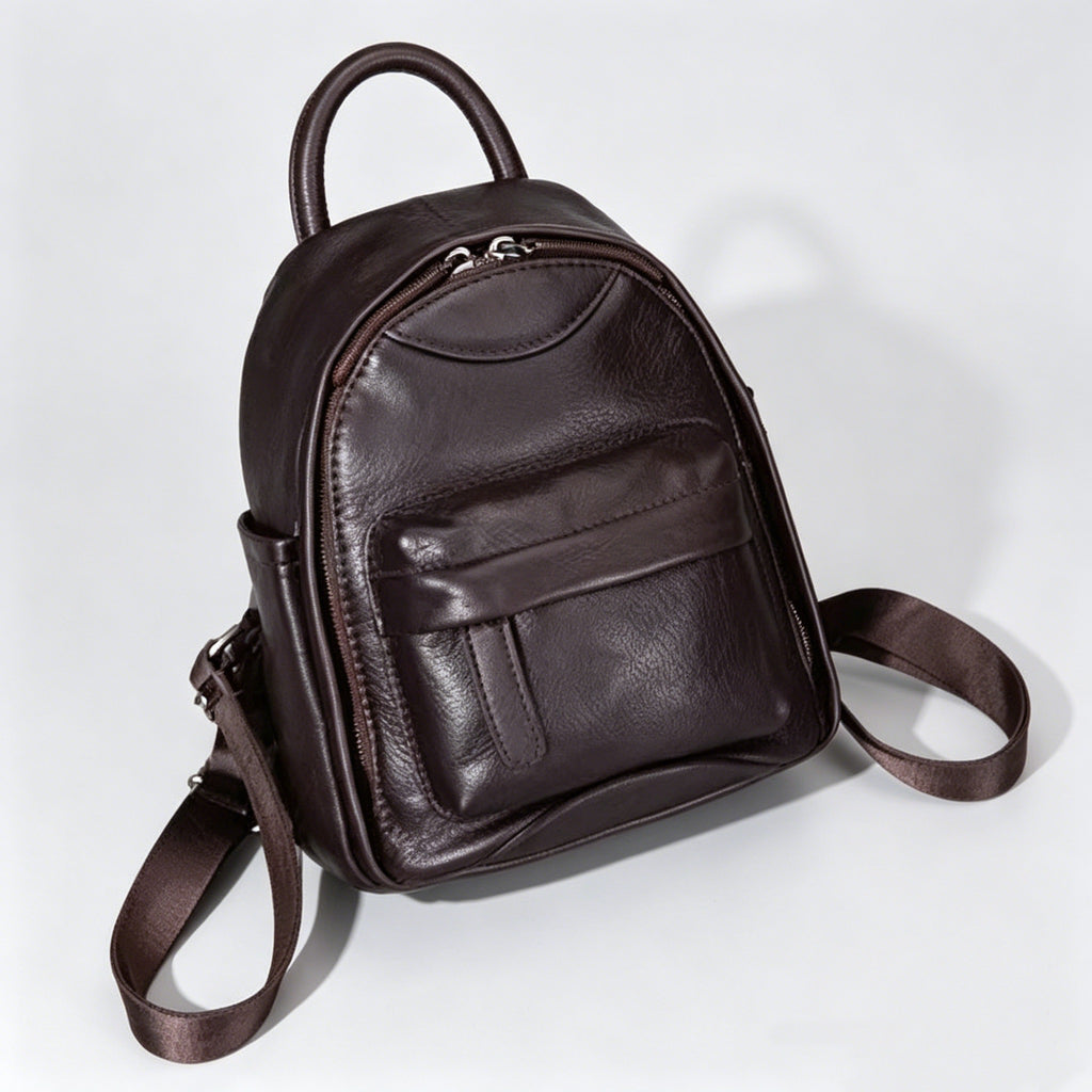 Brown leather backpack on a light gray background