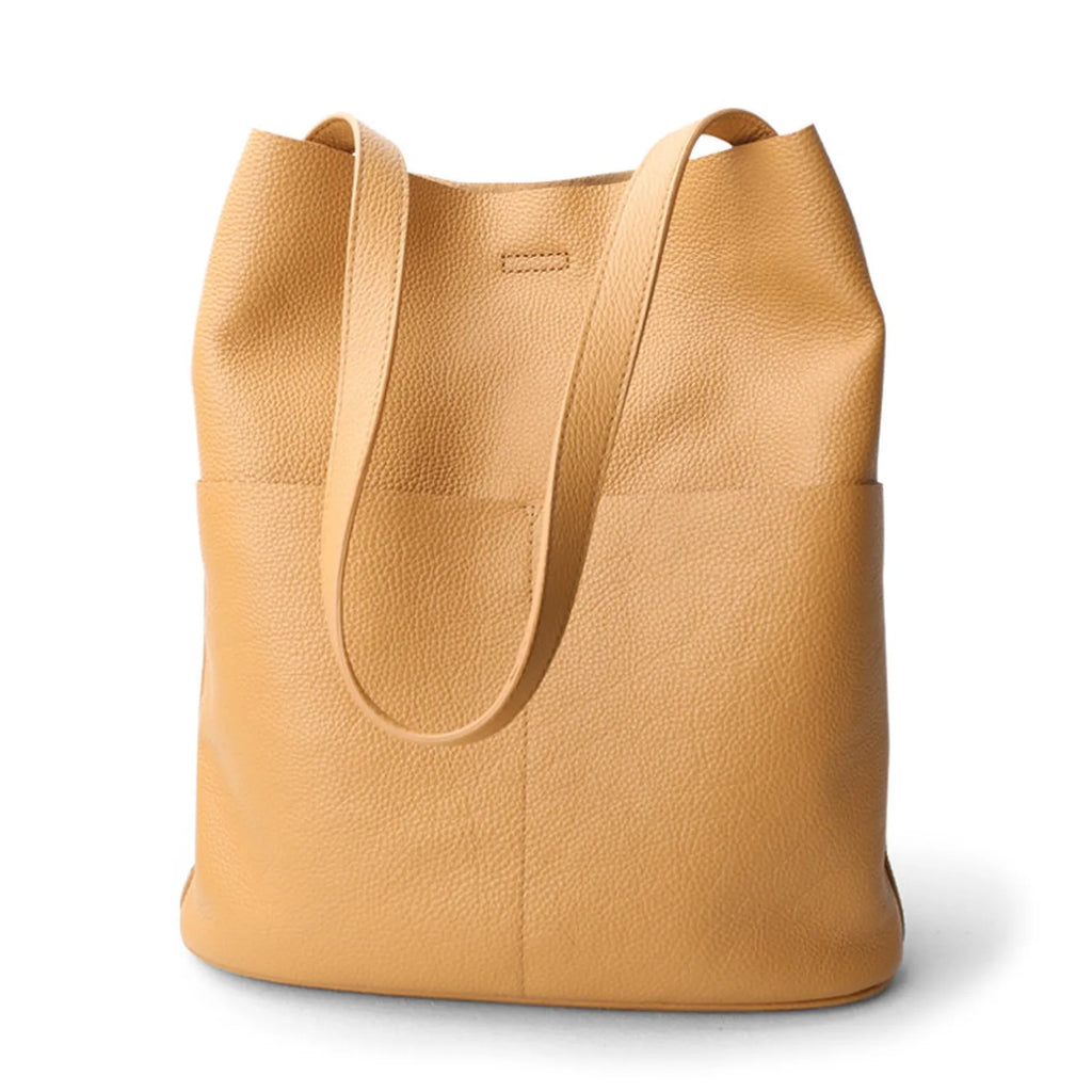 Tan leather tote bag on a white background