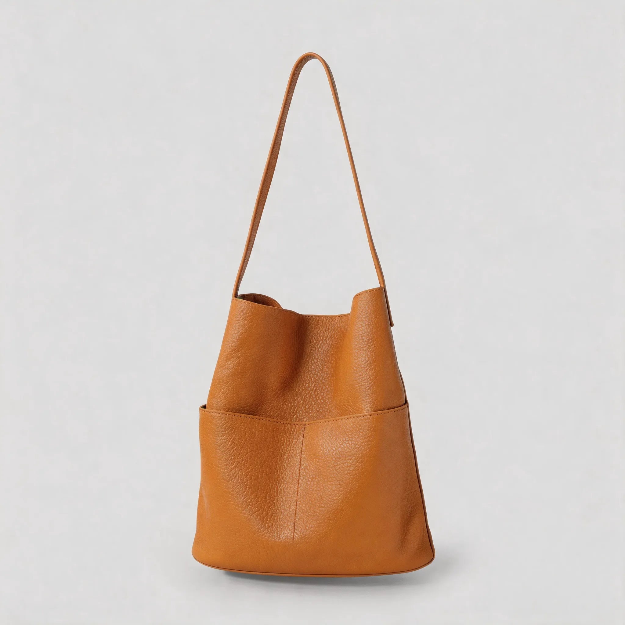 Brown leather handbag on a light gray background