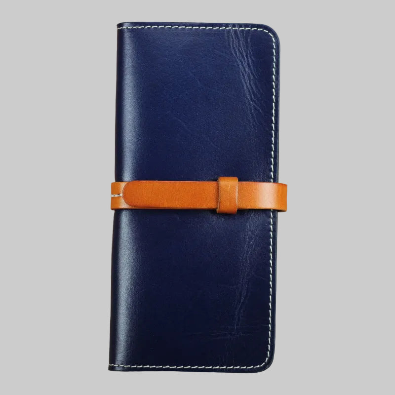 Blue leather wallet with a brown strap on a beige background