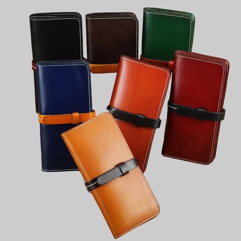 Collection of leather wallets in various colors on a textured surface