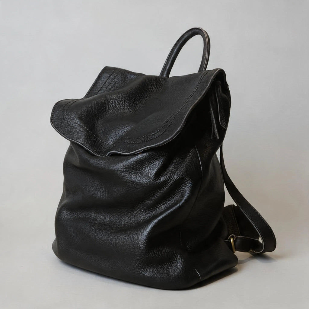 Black leather backpack on a light gray background