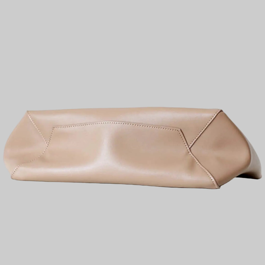 Beige clutch bag on a light gray background