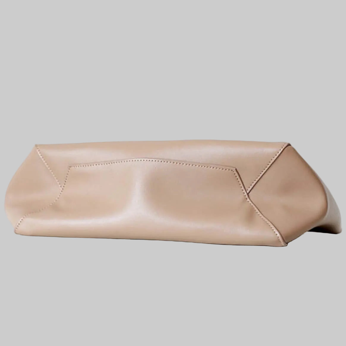 Beige clutch bag on a light gray background